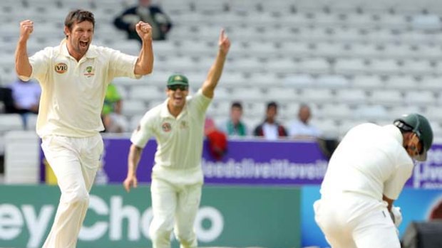 Australia's Ben Hilfenhaus, left, celebrates after taking the wicket of Pakistan's Umar Akmal.