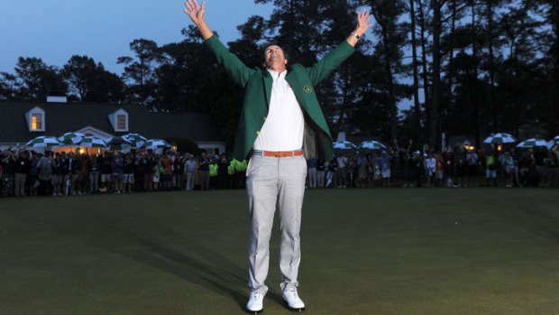 Adam Scott celebrates after being presented with the Masters green jacket.