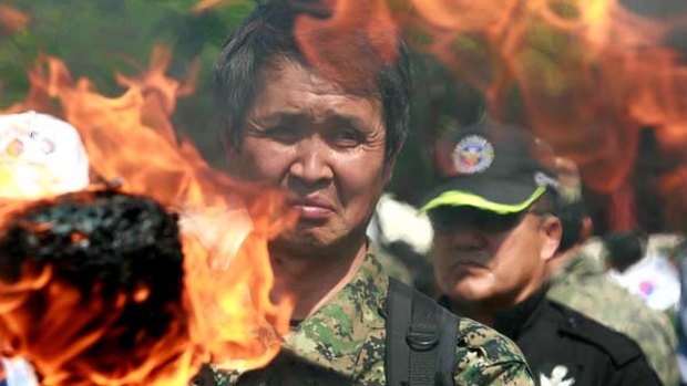 The heat is on ... a fire is lit at an anti-North Korea rally attended by South Korean war veterans in front of City Hall in Seoul this week.