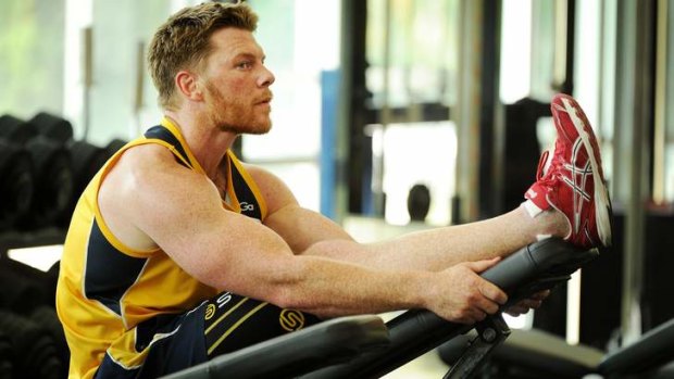 Brumbies winger Clyde Rathbone works out in the gym.
