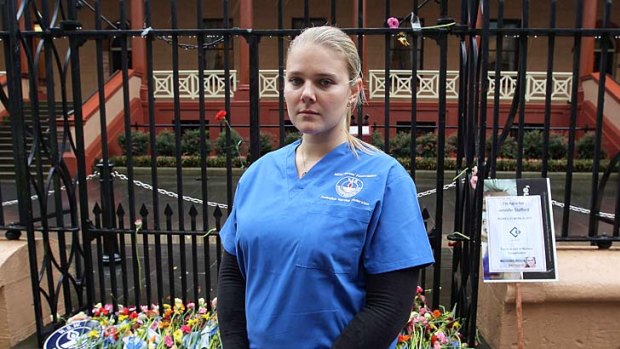 Injured on the job ... nurse Emily Orchard at the protest against the proposed cuts yesterday.