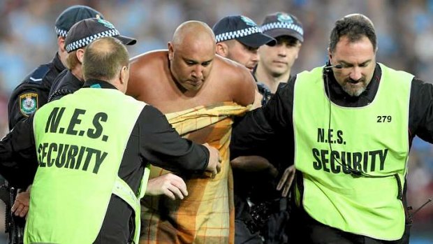Sent off: a streaker is escorted from the field.