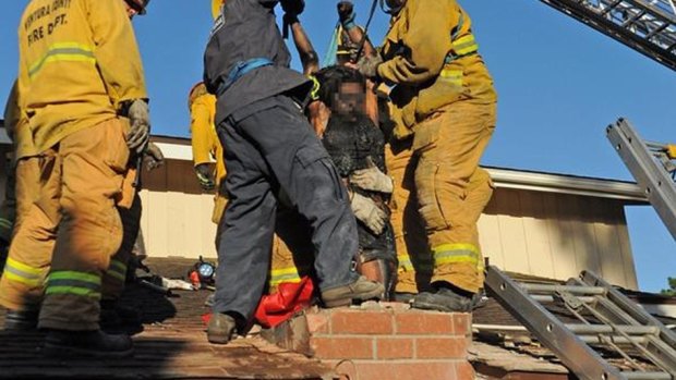 The woman is removed from the chimney.