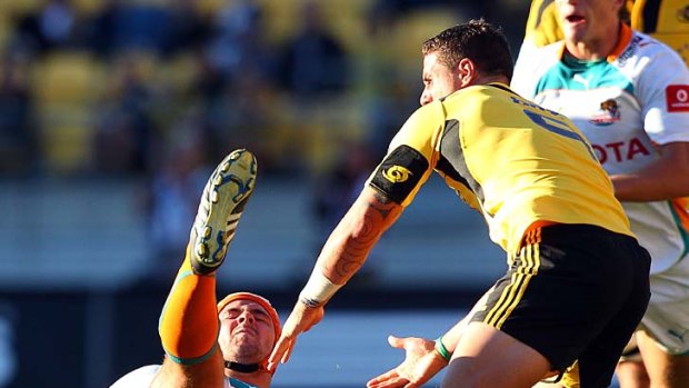 Heinrich Brussow of the Cheetahs is hit in a late tackle by TJ Perenara.