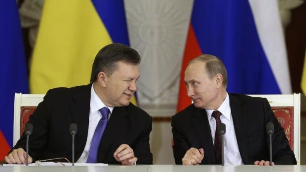 Signed: Ukrainian President Viktor Yanukovych gives a wink to his Russian counterpart Vladimir Putin.