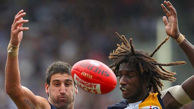 Ball hungry: ruckmen Dean Cox (left) and Nic Naitanui of West Coast make a joint attack in Perth yesterday.