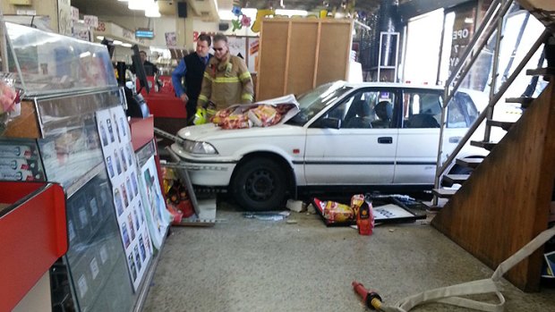 The car smashed though the supermarket's front window.