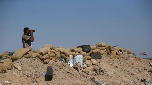 An Iraqi Army soldier watches fellow troops assault Islamic State fighters in Anbar province on Tuesday.