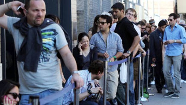 People queue outside an Apple store in Manhattan to purchase the new iPad 3G. It went on sale at 5pm Friday New York Time.  Photo: Mario Tama/Getty Images/AFP