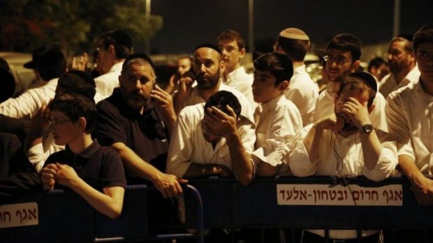 Israelis gather in the town of Elad, outside the home of Eyal Yifrach, one of the three teenagers.