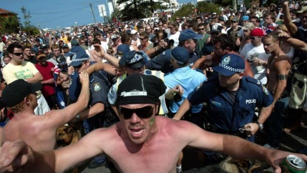 In real life ... an angry crowd shout racial taunts against Lebanese Australians at North Cronulla Beach on December 11, 2005.