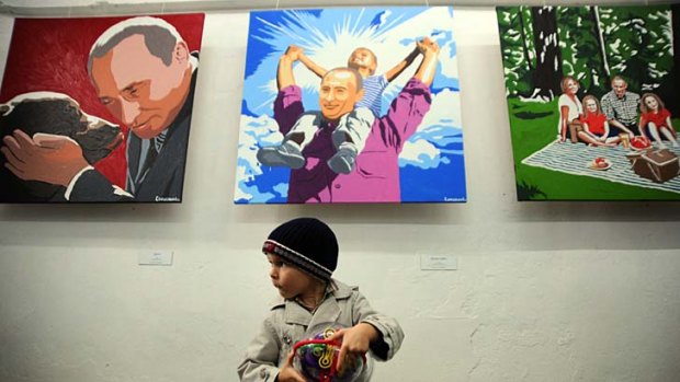 Cult of personality ... a boy visits the exhibition <i>President: the Kindest Person in Moscow</i>, part of the celebrations held across Russia to mark Vladimir Putin's 60th birthday on Sunday.