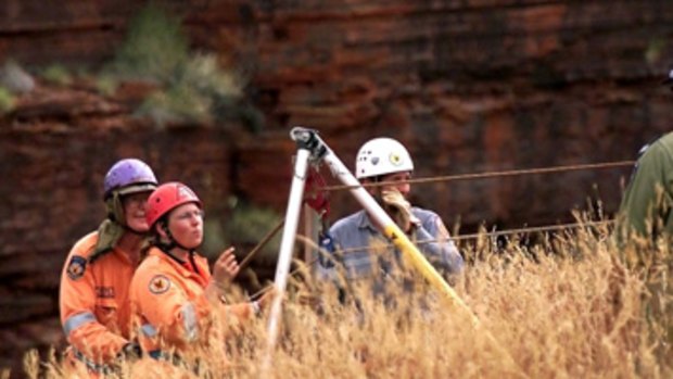 SES volunteers organise their winch at the edge of Hancock Gorge following the death of James Regan.