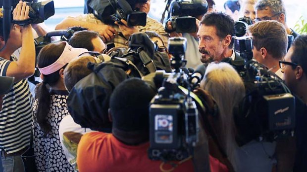 Scrum ... John McAfee talks to the media outside his Miami hotel.