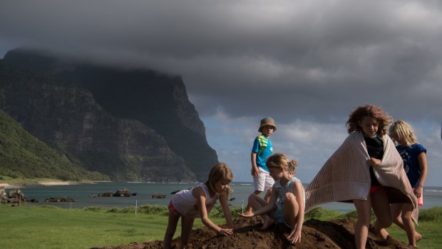 Local children gather at the site where scientists exhume a whale skeleton. Photo: Wolter Peeters