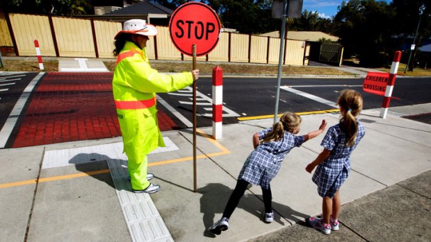 School crossing supervisor Judy Bray on call to stop traffic for students.