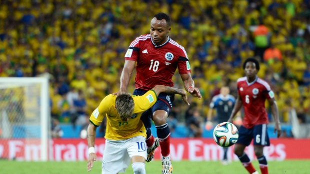 Colombia's defender Juan Camilo Zuniga (red jersey) knees Brazil's forward Neymar in the back. The foul and subsequent injury knocked Neymar out of the semi-final against Germany. 