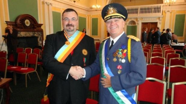 Dressed for the occasion: George II, left, head of Atlantium, greets the President of Molossia, Kevin Baugh.