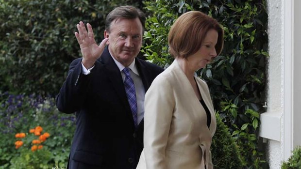 Prime Minister Julia Gillard and partner Tim Mathieson arrive for the ceremony at Government House.