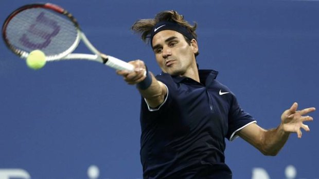 No answers: Roger Federer hits a return to Tomas Berdych during their men's quarter-final.