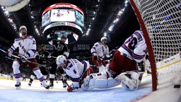 Mike Richards of the Los Angeles Kings celebrates as Henrik Lundqvist  of the New York Rangers gives up the game-winning goal.