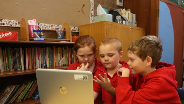 School children work off a computer at Darlington Public School. 