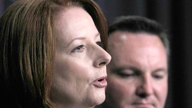 Prime Minister Julia Gillard and Immigration Minister Chris Bowen: Deal with Malaysia a "big blow" to people smugglers.