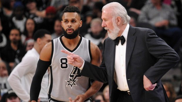 Patty Mills and Spurs coach Gregg Popovich.