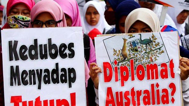 Tension continues: Protesters rally in front of the Australian Embassy building in Indonesia.