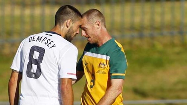 Australia's Craig Moore argues with Clint Dempsey of the U.S. during their World Cup warm-up match at the Ruimsig stadium in Roodepoort.