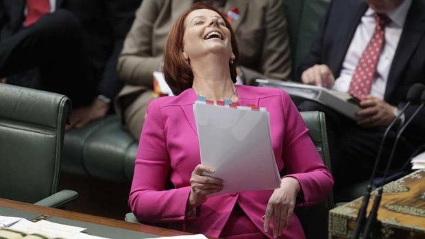 Prime Minister Julia Gillard reacts as Opposition Leader Tony Abbott addresses AWU allegations.
