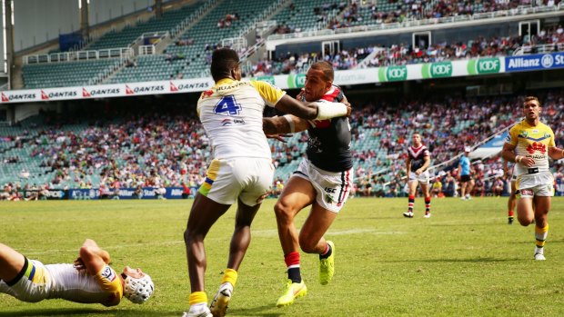 Blake Ferguson of the Roosters beats Edrick Lee of the Raiders to score a try.