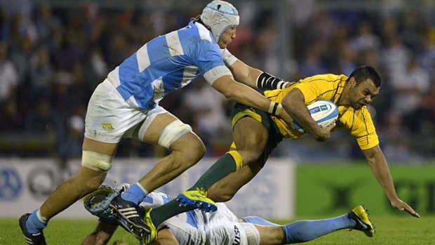 Pouncing Puma: Wallaby Kurtley Beale is tackled by Argentinian lock Patricio Albacete.
