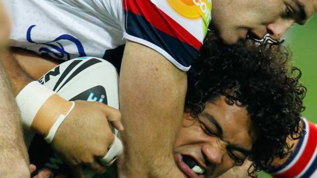 The Storm's Adam Blair is going nowhere as the Roosters wrap him up last night.