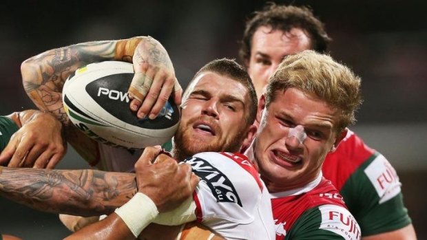 Dragons fullback Josh Dugan is brought under control against South Sydney at the SCG.
