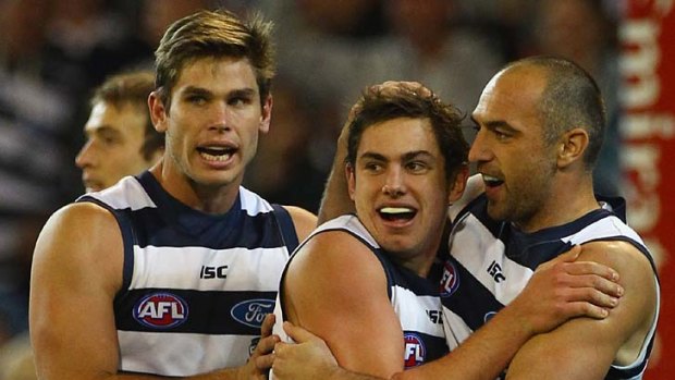 How about that: Geelong's Dan Menzel (centre) celebrates a goal on Friday night with Tom Hawkins (left) and James Podsiadly.