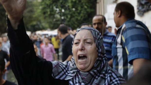 A Palestinian woman chants slogans as mourners carry the body of a 7-year-old killed in the explosion.