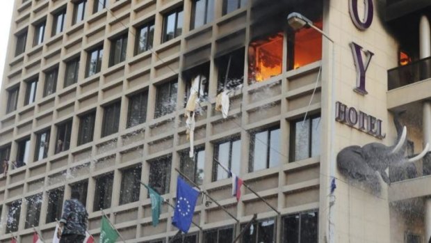 Firefighters put out a fire at Duroy hotel following a bomb attack in Beirut.