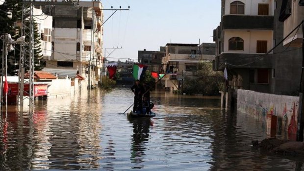 Civil defence teams in Gaza try to rescue people caught in flooding in December 2013.