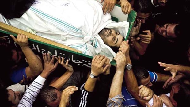 Palestinian mourners carry the coffin of Sami Sirhan.