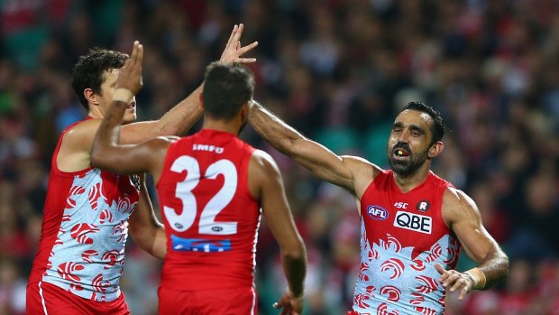 Over she goes: Adam Goodes of the Swans celebrates kicking a goal.