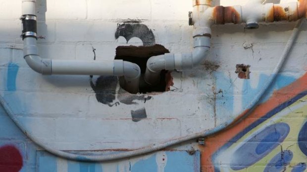 In Australia .... Banksy street art of a parachuting rat is destroyed by pipes being put through that spot.