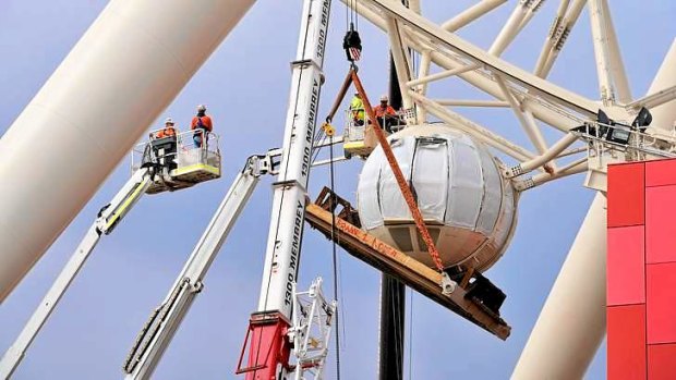 Passenger pods of the Docklands observation wheel being installed.