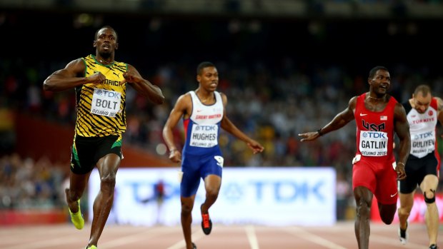 Usain Bolt (left) of Jamaica crosses the finish line to win gold in the 200m ahead of Justin Gatlin (right) of the US.