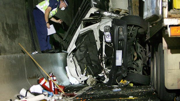 Carnage ... A vehicle is crushed between a truck and the wall of the Burnley Tunnel in the 2007 crash.