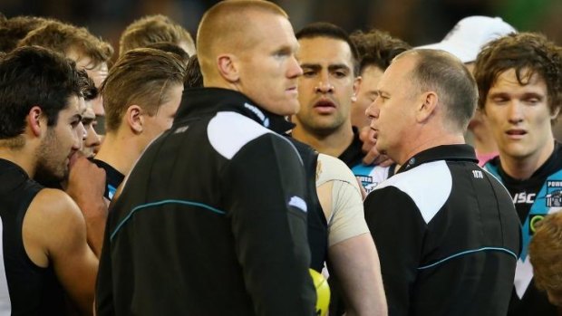 Ken Hinkley talks to his players during a break in the game.