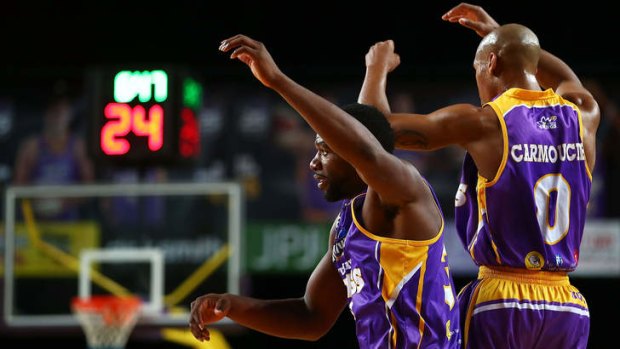 Kings imports Sam Young and Charles Carmouche celebrate after the forward's dunk against the Hawks but Sydney ended up losing by six.