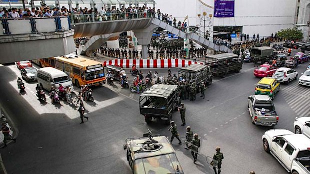 Soldiers and police officers take position to stop protests against military at a shopping district in Bangkok June 1, 2014.