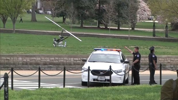 The gyrocopter (left) landed on the west lawn of the US Capitol in Washington. One person was detained and nearby streets were temporarily closed as police investigated.