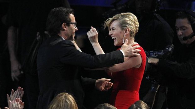 Kate Winslet reacts after her co-star Guy Pearce won outstanding supporting actor in a miniseries or movie for "Mildred Pierce" at the 63rd Primetime Emmy Awards.